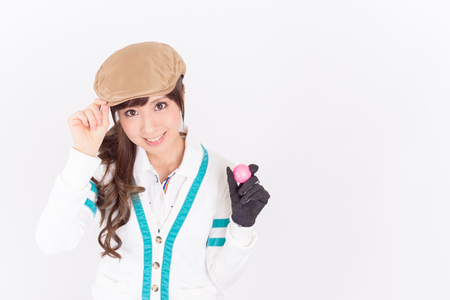 Young woman golf player smiling isolated on white background.の写真素材