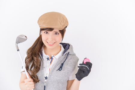 Young woman golf player smiling isolated on white background.の写真素材