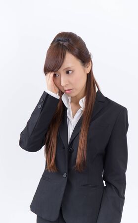 Japanese young woman with a headache holding head, isolated on white backgroundの写真素材