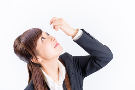 japanese young woman put in the eye dropsの写真素材
