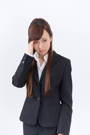Japanese young woman with a headache holding head, isolated on white backgroundの写真素材