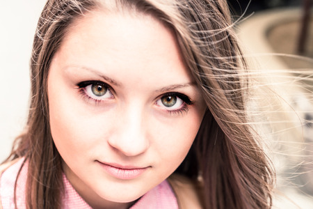 portrait of serious beautiful effective girl outdoorの写真素材