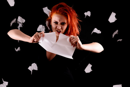 emotional girl on a hard work tears documentsの写真素材