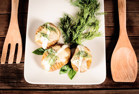 prepared chopped potatoes are served on dish with basil sauce and fennelの写真素材