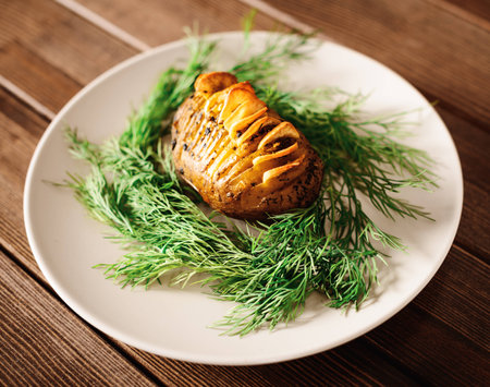 prepared chopped potatoes are served on dish with basil sauce and fennelの写真素材