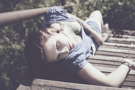 beautiful woman with a tattoo in vintage style outdoorsの写真素材