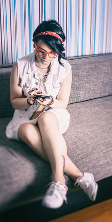 girl hipster have fun in vintage style fond of phoneの写真素材