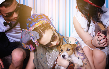 company of young hipsters have fun with dog has good time house leisureの写真素材