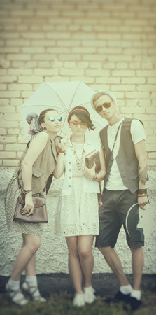 young active guy and girls hipsters have a good time outdoorsの写真素材