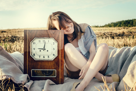 young beautiful unusual girl illustrates conceptual idea with watchの写真素材