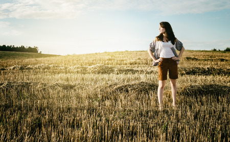 young beautiful free lonely woman walks across the fieldの写真素材