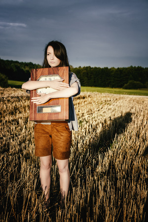 young beautiful unusual girl illustrates conceptual idea with watchの写真素材