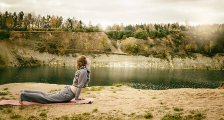 man outdoors practices yoga and leads healthy lifestyleの写真素材