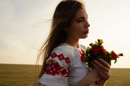 young woman in a Slavic Belarusian national original suit outdoors