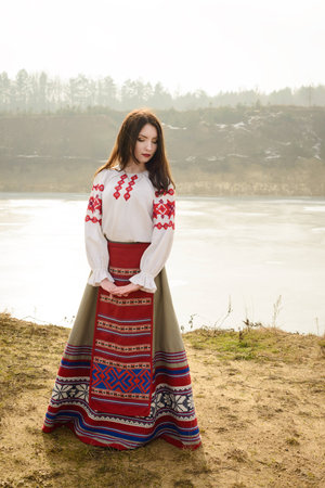 young woman in a Slavic Belarusian national original suit outdoorsの写真素材