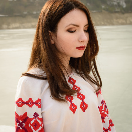 young woman in a Slavic Belarusian national original suit outdoorsの写真素材