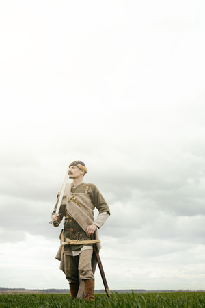 man in ethnic suit in context of historical reconstruction outdoorの写真素材