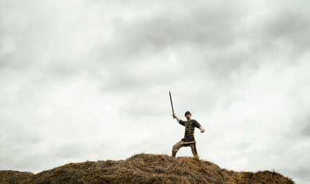 man in ethnic suit in context of historical reconstruction outdoorの写真素材