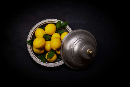 Fresh lemons on dark stone background. Top view.の写真素材