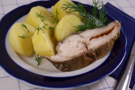 Smoked fish with vegetables on a platterの写真素材