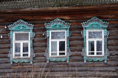 YAROSLAVL REGION, RUSSIA - MARCH, 2016: The facade of the old wooden houses with carved architravesのeditorial素材