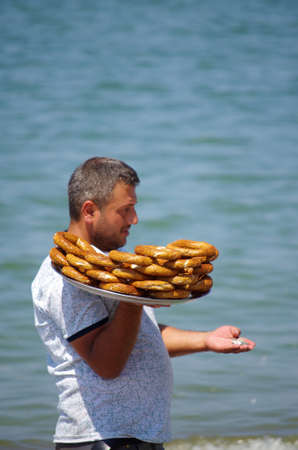 FETHIYE, TURKEY - June, 2019: Seller sells bagels on the Calis beach on the Aegean Seaのeditorial素材