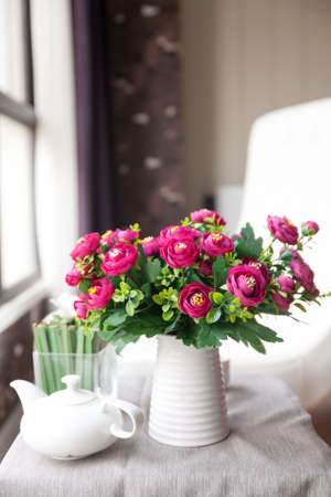 White vase, with red flowersの写真素材