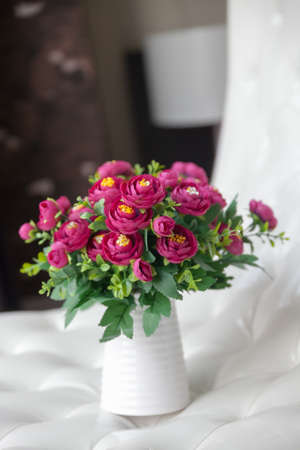 White vase, with red flowersの写真素材