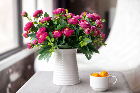 White vase, with red flowersの写真素材