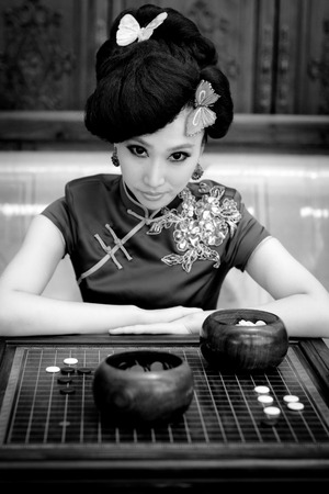 Woman wearing a cheongsam, Chinese classical costumes,In chessの写真素材