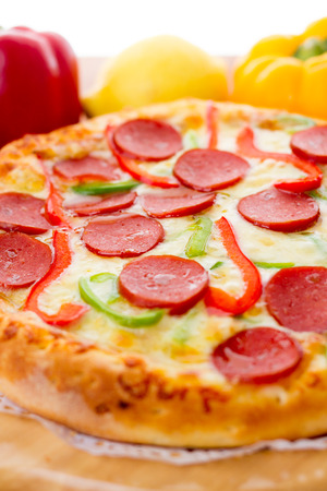 Delicious sausage pizza, on the chopping boardの写真素材