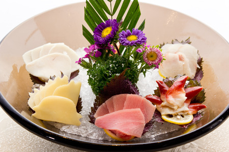 An assortment of different types of sashimi served on a delicate set up.の写真素材
