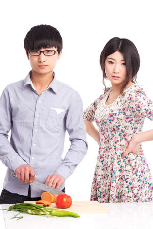 Asian couple in cooking, online learning recipesの写真素材