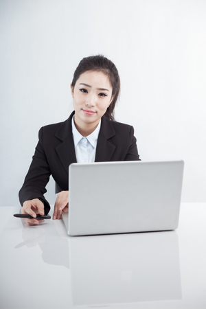 Asian business woman using laptop at workの写真素材