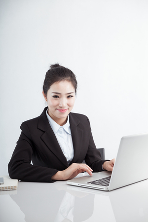 Asian business woman using laptop at workの写真素材