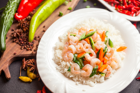 rice served with meat and vegetables on topの写真素材