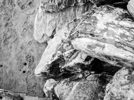 Abstract natural stones and sand on a beautiful sea on a vacation day processed in monochrome. High detail for background, wallpaper or backdrop.の写真素材