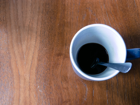 Coffee cup on a wooden desk.の写真素材