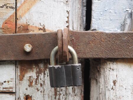 Wooden painted vintage old door with padlockの写真素材