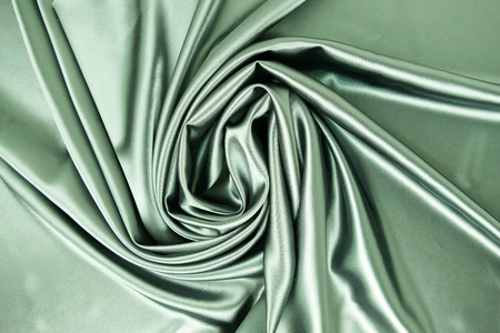 Smooth elegant khaki color silk or satin luxury cloth fabric texture, abstract background design.の写真素材