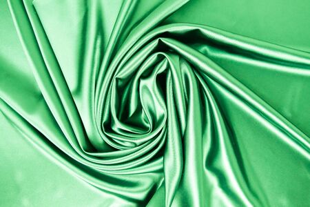 Smooth elegant green color silk or satin luxury cloth fabric texture, abstract background design.の写真素材