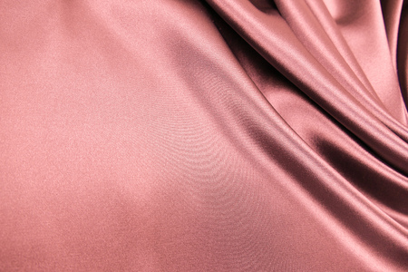 Smooth elegant rose pink color silk or satin luxury cloth fabric texture, abstract background design.の写真素材