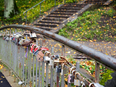 Old stairs with autumn leaves in the city park.