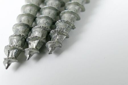 Set of screws on the white background , metal screw, steel screw, screw macroの写真素材