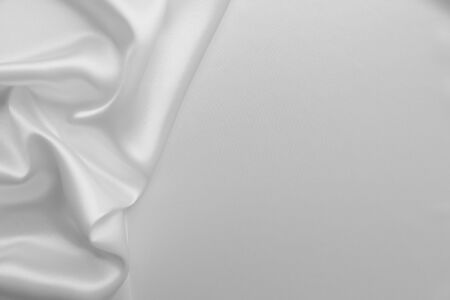 Smooth elegant white color silk or satin luxury cloth fabric texture, abstract background design.の写真素材