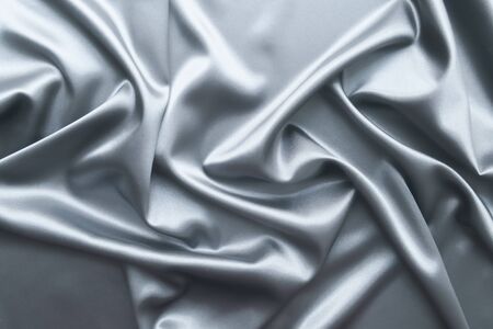 Smooth elegant dark grey or silver silk or satin luxury cloth fabric texture, abstract background design.の写真素材