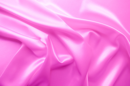 Beautiful smooth elegant wavy hot baby pink satin silk luxury cloth fabric texture, abstract background design. Copy spaceの写真素材