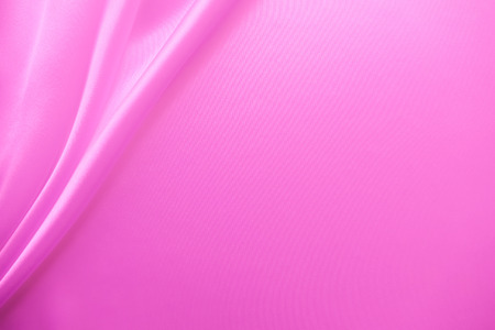 Beautiful smooth elegant wavy hot baby pink satin silk luxury cloth fabric texture, abstract background design. Copy spaceの写真素材