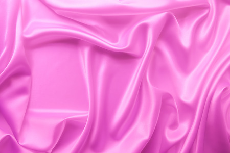 Beautiful smooth elegant wavy hot baby pink satin silk luxury cloth fabric texture, abstract background design. Copy spaceの写真素材