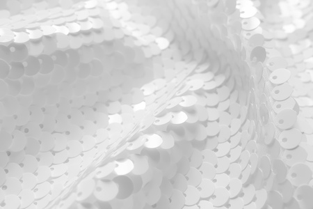 Background sequin. Holiday abstract glitter background with blinking lights. Fabric sequins in white color. Fashion fabric glitter.の写真素材